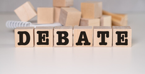 Wooden Blocks with the text: Debate on white background.