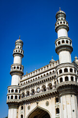 The Minarets of the Charminar Mosque Contrast against a Clear Blue Sky in Hyderabad, India