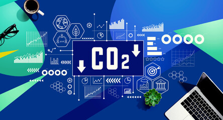 Reduce CO2 theme with a laptop computer on a blue and green pattern background