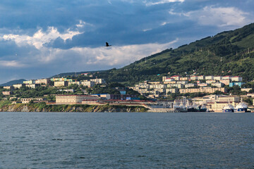 Fototapeta premium The Pacific Ocean, ships, mountains, many houses on the mountain, Kamchatka.