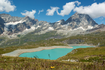 Naklejka na ściany i meble The Matterhorn mountain peak with Lake Goillet in the foreground, Italy
