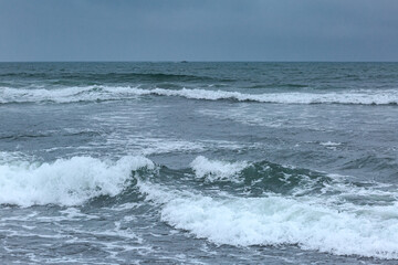 Waves of the Pacific Ocean, coast, rain, cloudy weather, Kamchatka, water.