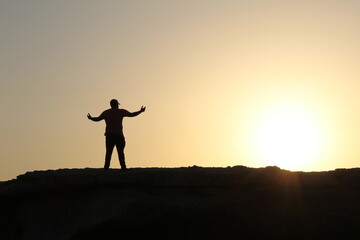 silhouette of a person on the top of mountain