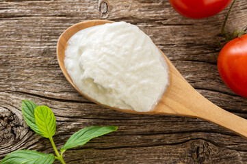Homemade Yogurt with cream in a wooden spoon, healthy food