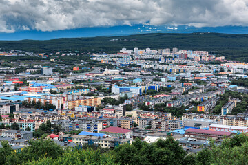 Kamchatka, city, houses, against the backdrop of mountains, clouds.