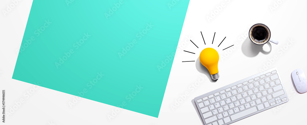 Poster computer keyboard with a yellow light bulb from above