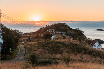 Sunset in Norway with little house and powerline