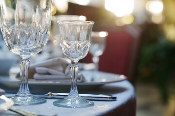 empty wine glasses on the table.table setting for a festive dinner. solar glare.
