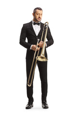 Obraz premium Full length portrait of a male musician holding a trombone and looking down