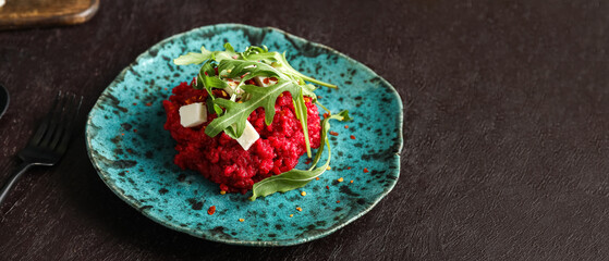 Plate with tasty beet risotto on dark background