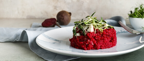 Plate with tasty beet risotto on light background, closeup