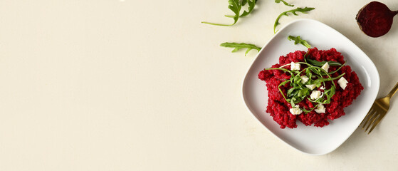 Plate with tasty beet risotto on light background with space for text