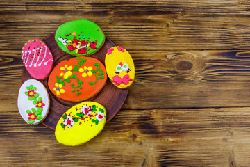 Egg shaped easter gingerbread cookies on wooden table. Top view. Sweets for celebrate Easter