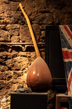 A musical instrument, one of the symbols of eastern and western civilization, and the flag of England on the wall , concept of abandoned space , book cover idea