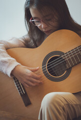 Little girl plays the guitar.