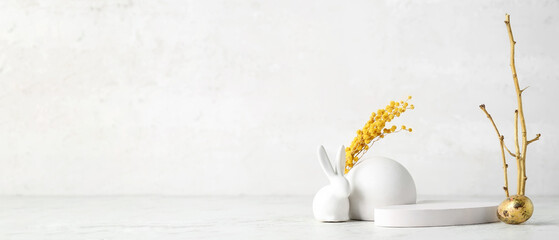 Empty podiums with spring flowers, Easter egg and bunny on light background with space for text