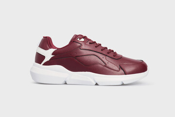 Classic fashion leather women's burgundy sneakers shoe for fitness gym running jogging isolated on white background. Template, mock up