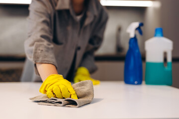 Cleaning hygiene, young maid woman, girl hand in using a water sprayer bottle to wipe clean, use...