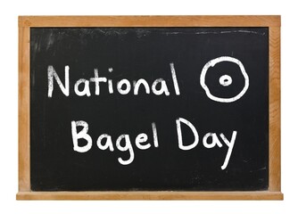 National Bagel Day written in white chalk on a black chalkboard isolated on white