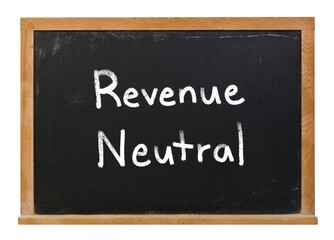 Obraz premium Revenue neutral written in white chalk on a black chalkboard isolated on white