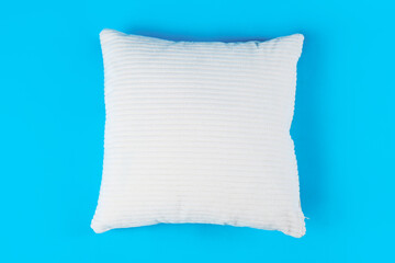 Soft pillow on blue background