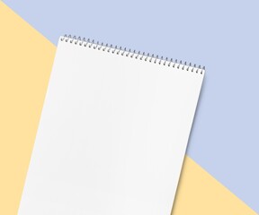 Blank desk office calendar or notebook on color background