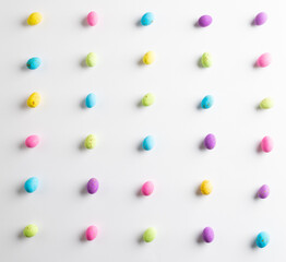 Image of multi coloured easter eggs with copy space on white background