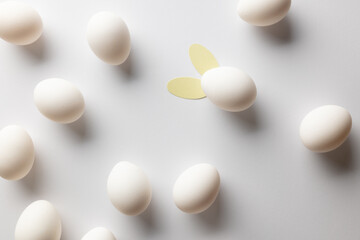 Image of white easter eggs with bunny ears and copy space on white background