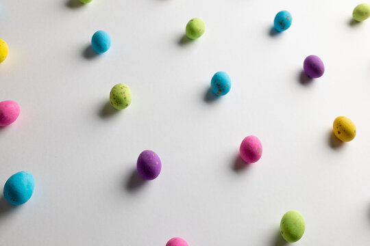 Image of multi coloured easter eggs with copy space on white background