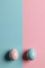 Image of pink and blue easter eggs and copy space on pink and blue background