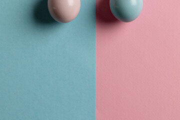 Image of pink and blue easter eggs and copy space on pink and blue background