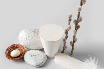 Composition with podiums, stones and willow branches on white background, closeup