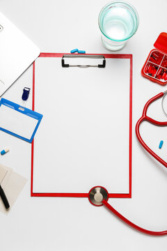 Blank Clipboard With Badge And Medical Supplies On White Background. World Health Day