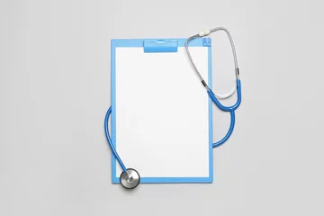 Foto op Plexiglas Blank clipboard with stethoscope on grey background. World Health Day © Pixel-Shot