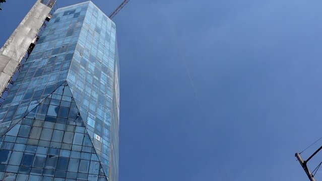 Skycraper city high rise glass building construction site with crane