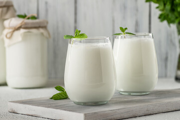 Glass cup of Turkish traditional drink ayran , kefir or buttermilk made from yogurt, healthy food - obrazy, fototapety, plakaty