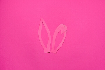 Paper bunny ears on pink background