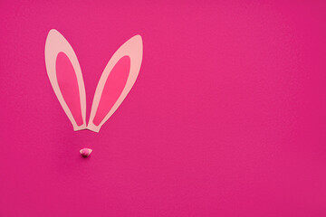 Paper bunny ears on pink background