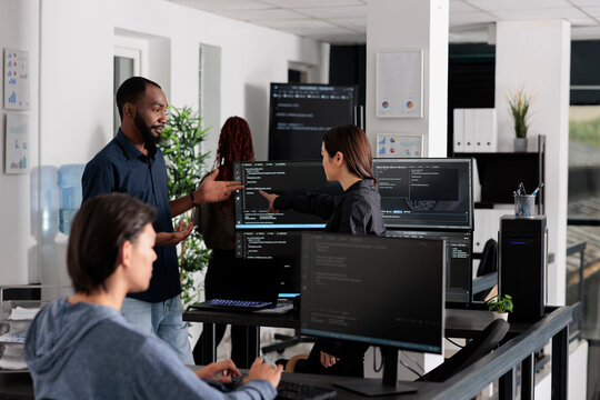 App software developer typing machine learning html code on computer, sitting at desk in it big data office. Cloud programer working on database system with coding script in software company,