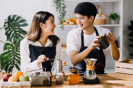 Image of newlywed couple cooking at home. Asia young couple cooking together with Bread and fruit in cozy kitchen in home