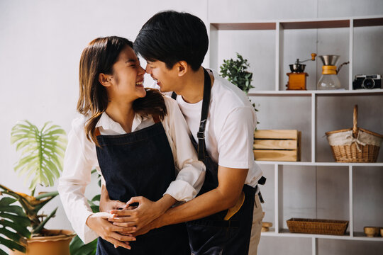 Image of newlywed couple cooking at home. Asia young couple cooking together with Bread and fruit in cozy kitchen in home