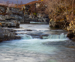 Smooth water landscape with small waterfall 