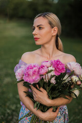 beautiful blonde woman with beautiful bouquet of peonies.
