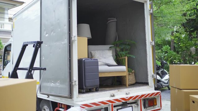 Truck car moving house for customers, delivering boxes and furniture. Vehicle transportation. Shipping and packaging business occupation service company. People lifestyle.