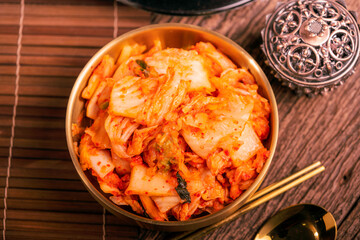 Korean pickle and seasoning Spicy Kimchi Korean traditional food, Kimchi salad made with vegetable cabbage and pepper in golden bowl.