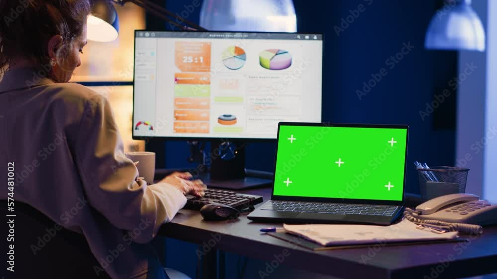 Poster business manager working with greenscreen on laptop, sitting at desk and looking at isolated mockup 