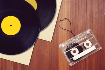 Vinyl records, and tape cassette on table. Retro concept