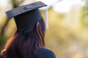 Rear view of gown and cap  a young Asian woman university graduate in graduation in university