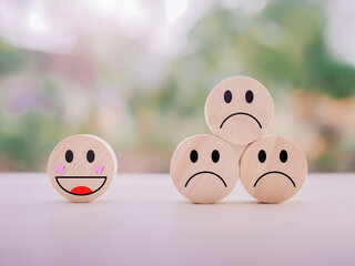 Emotion face wooden block. Customer service rating experience, feedback emotion and satisfaction survey.