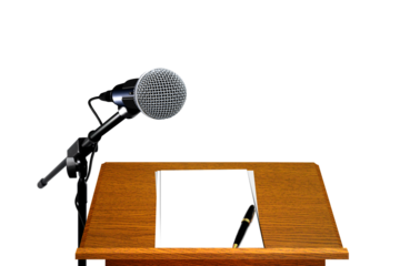 Microphone on podium with blank paper and pen.